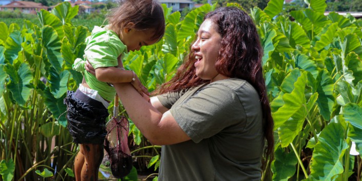Woman with a toddler in a field of taro (kalo)